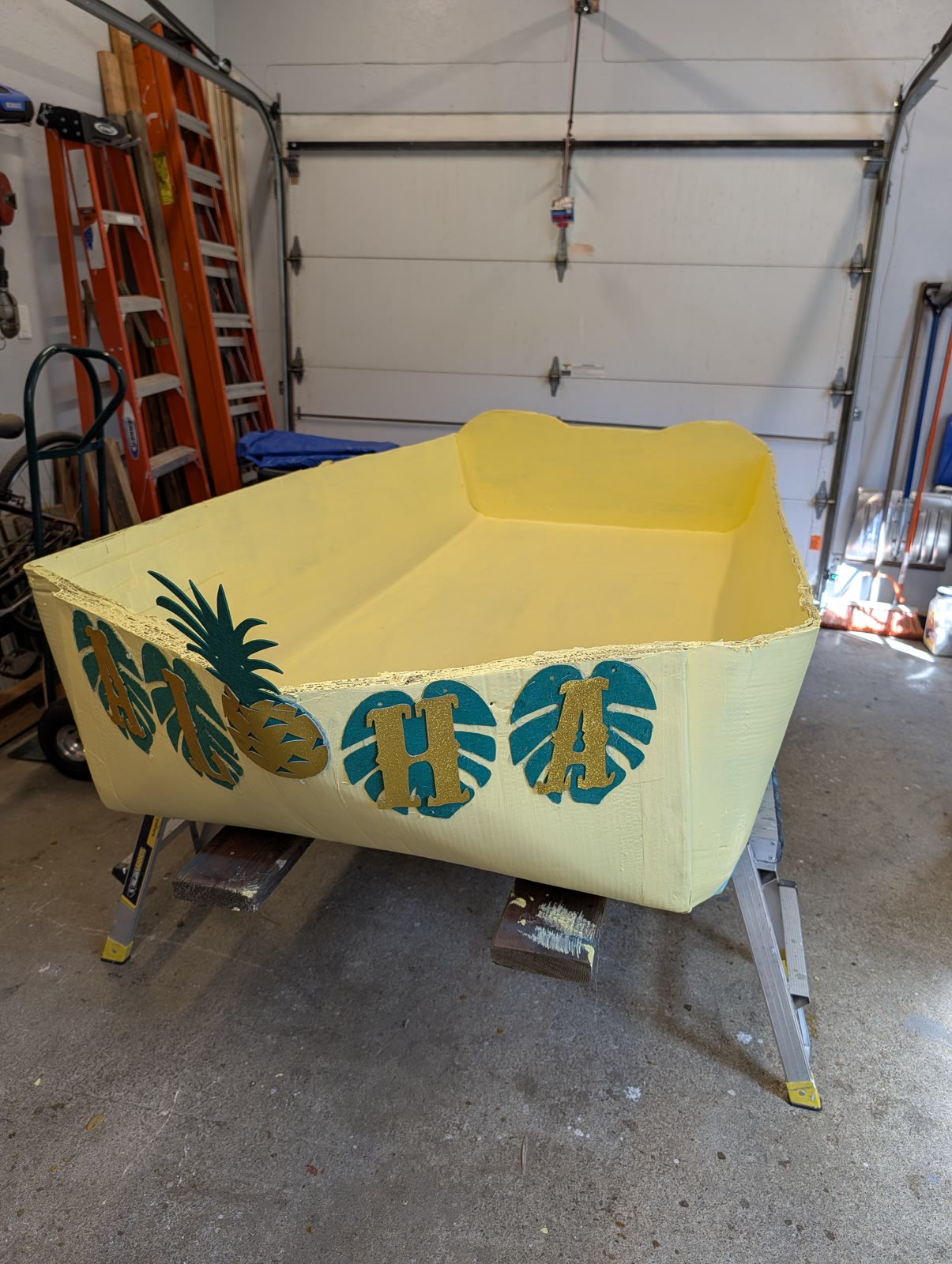 Decorated bow of The Unsinkable Luau with palm leaf and pineapple graphics