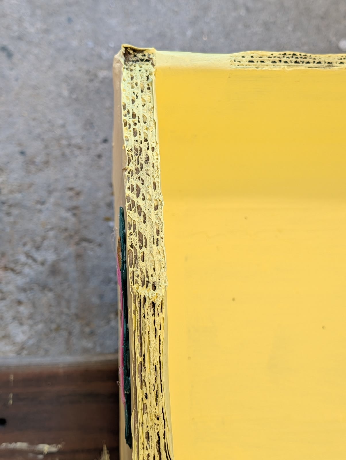 Layered corrugated cardboard visible along the boat’s gunwale