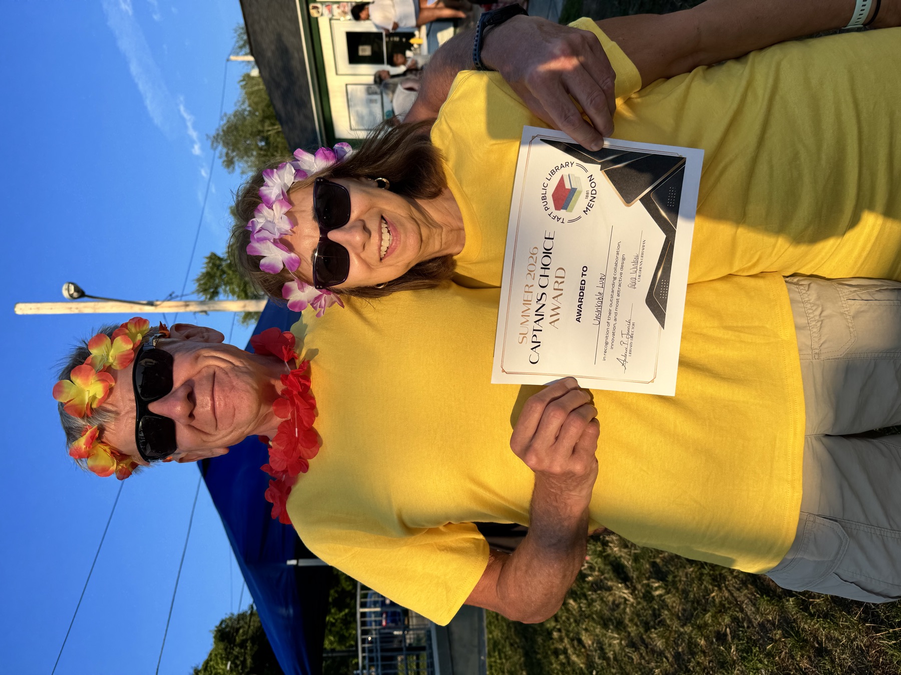 Captain Dan and a crew member holding The Unsinkable Luau's 2026 Captain's Choice Award
