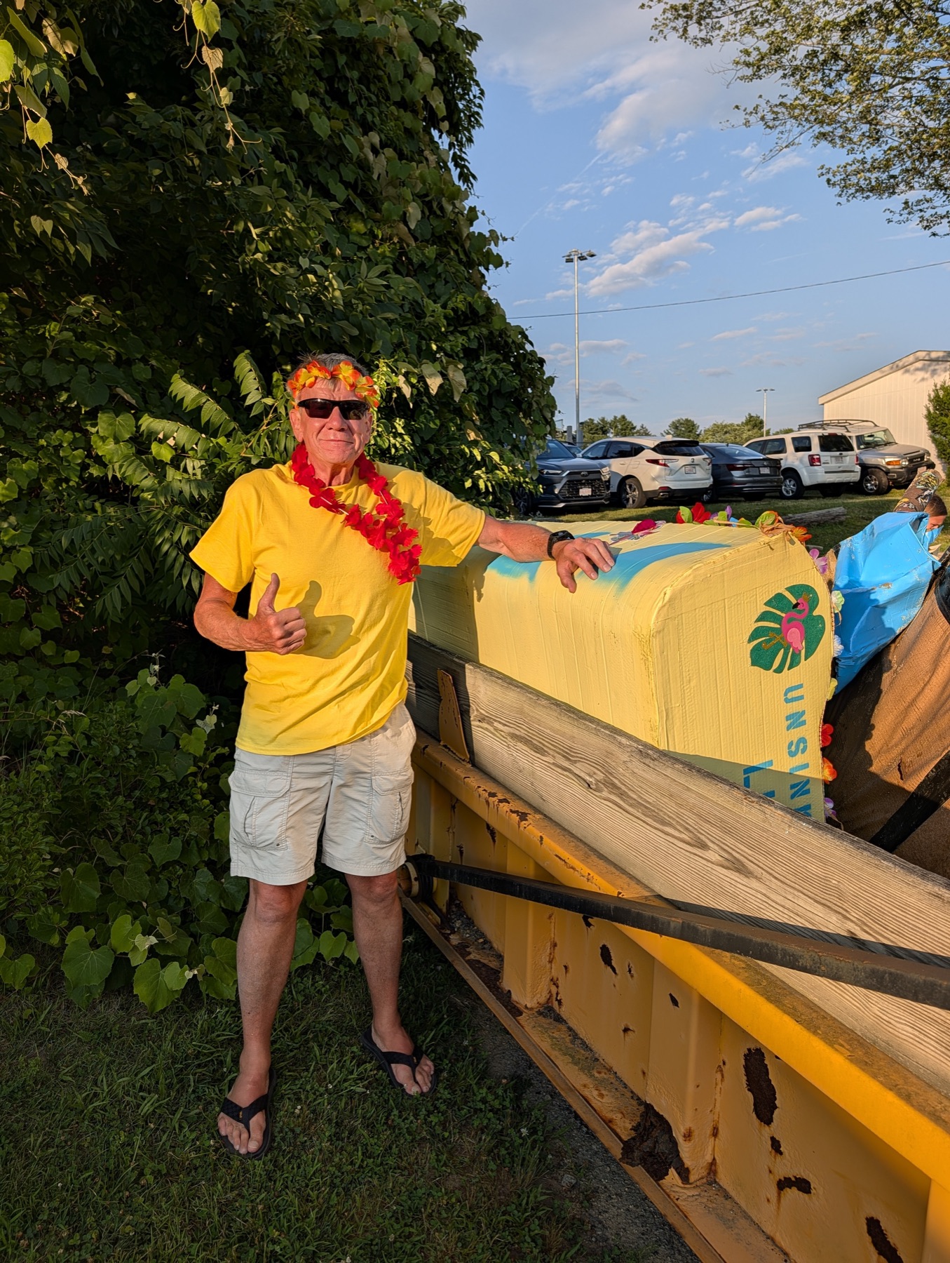 Captain Dan giving a thumbs-up beside the recovered 2026 race hull